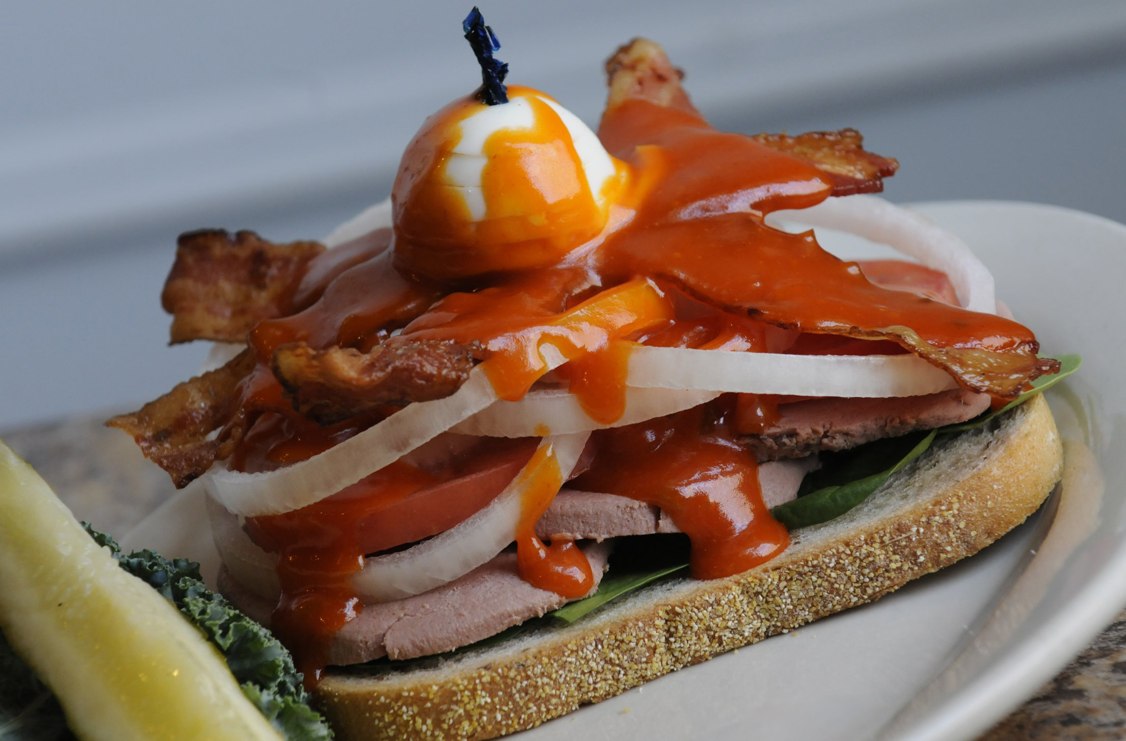 Max's Allegheny Tavern open Bavarian Club sandwich with rye bread, Milwaukee braunschweiger, bacon, sweet onion, tomato spinach & topped with an egg and secret sauce. (Pam Panchak / Post-Gazette )