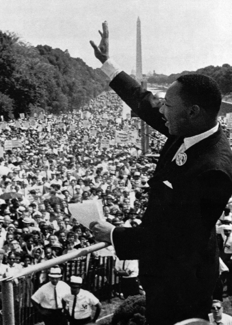 The Rev. Martin Luther King Jr. waves to the crowd. (UPI photo)