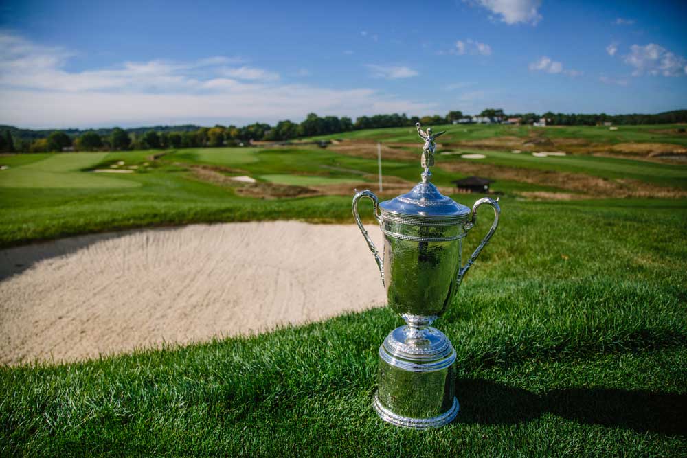 The U.S. Open Trophy is seen above a bunker along the third fairway at Oakmont Country Club. (Andrew Rush/Pittsburgh Post-Gazette)