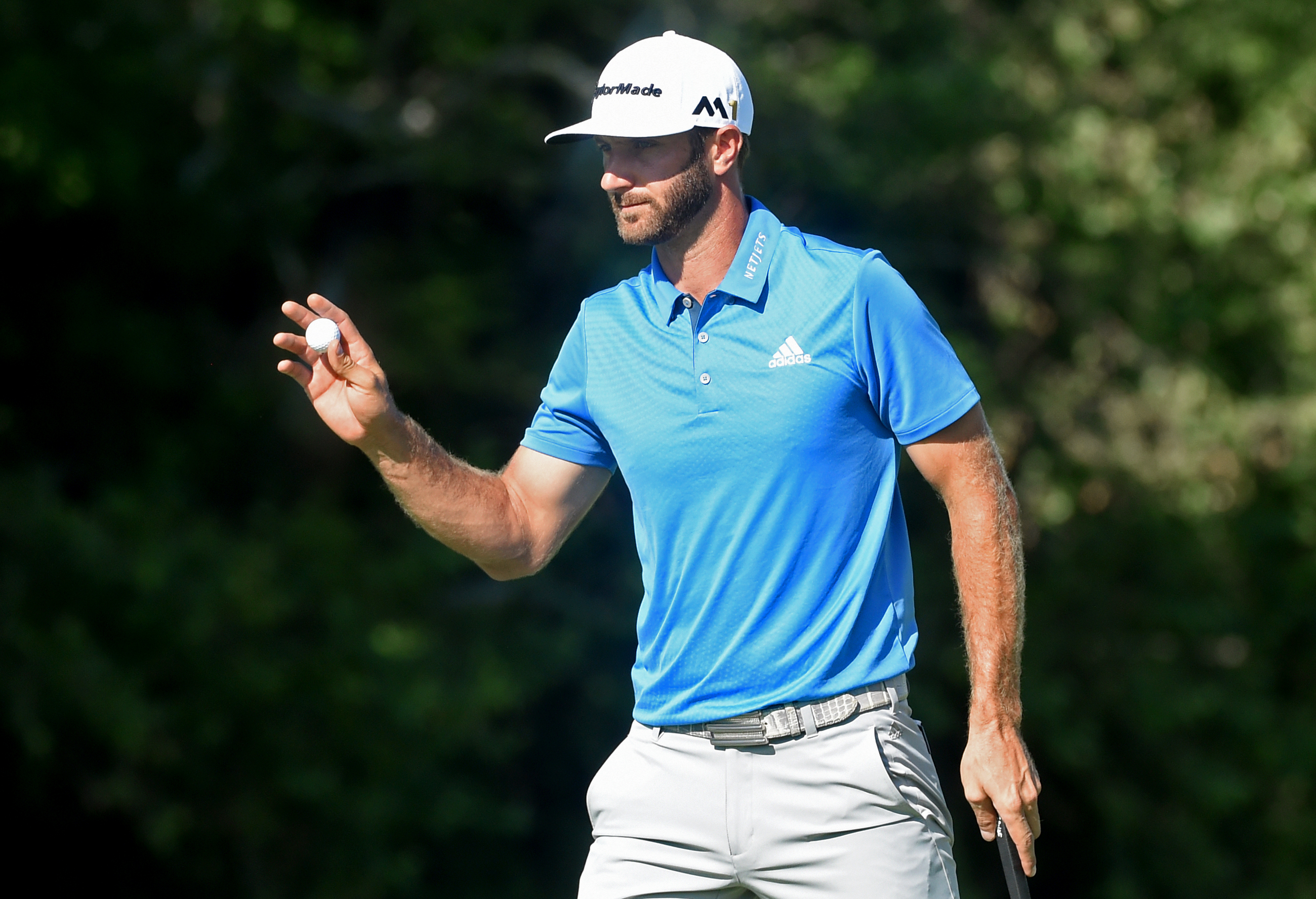 Dustin Johnson acknowledges the crowd on the 16th green Friday during the continuation of the first round of the U.S. Open at Oakmont Country Club. (Matt Freed/Post-Gazette)
