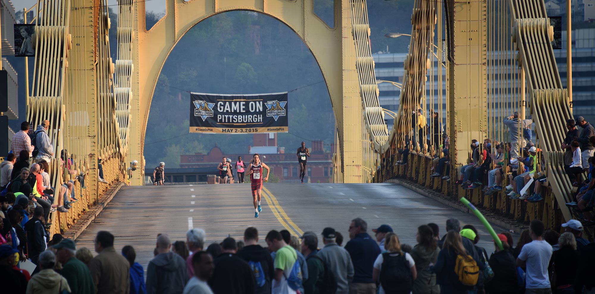 A crowd gathers on the Rachel Carson Bridge to cheer on the elite runners.  (Steve Mellon/Post-Gazette) 