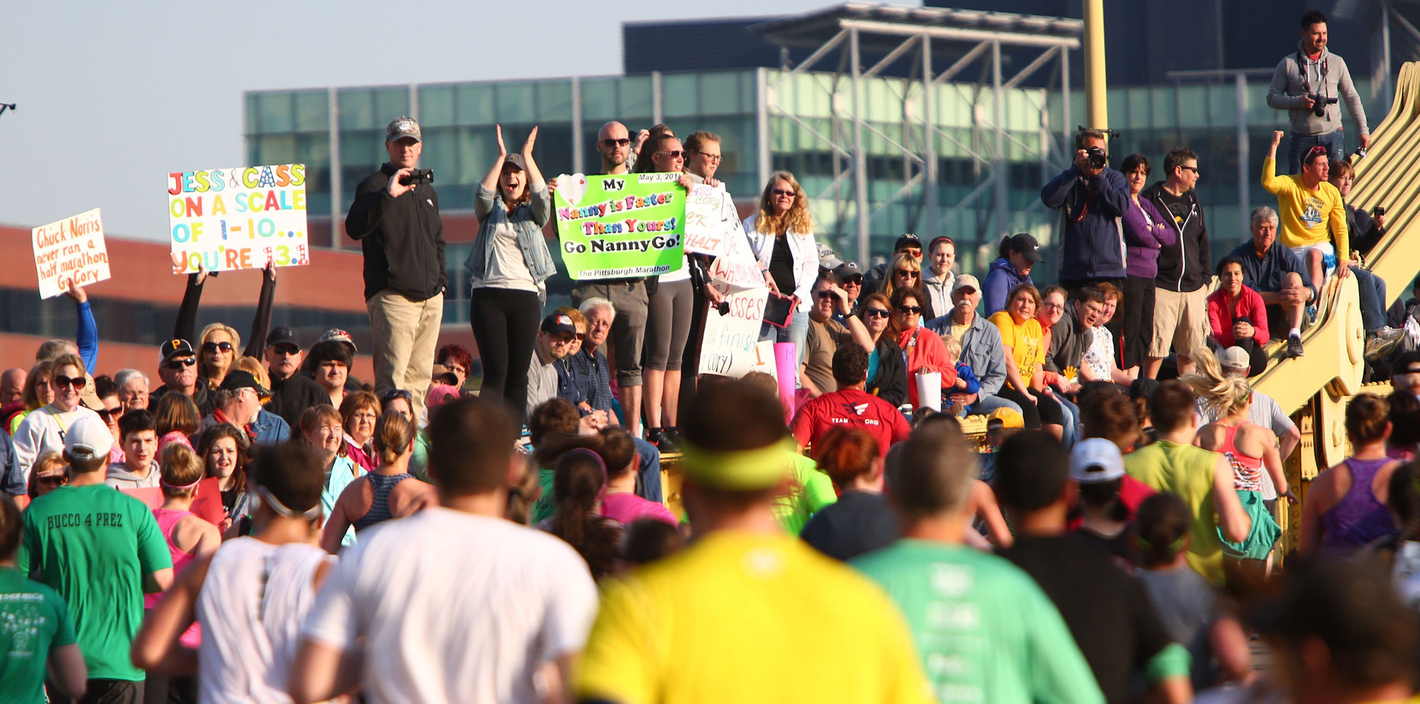 Crowd cheers runners as they cross the Rachel Carson Bridge. (Andrew Rush/Post-Gazette)