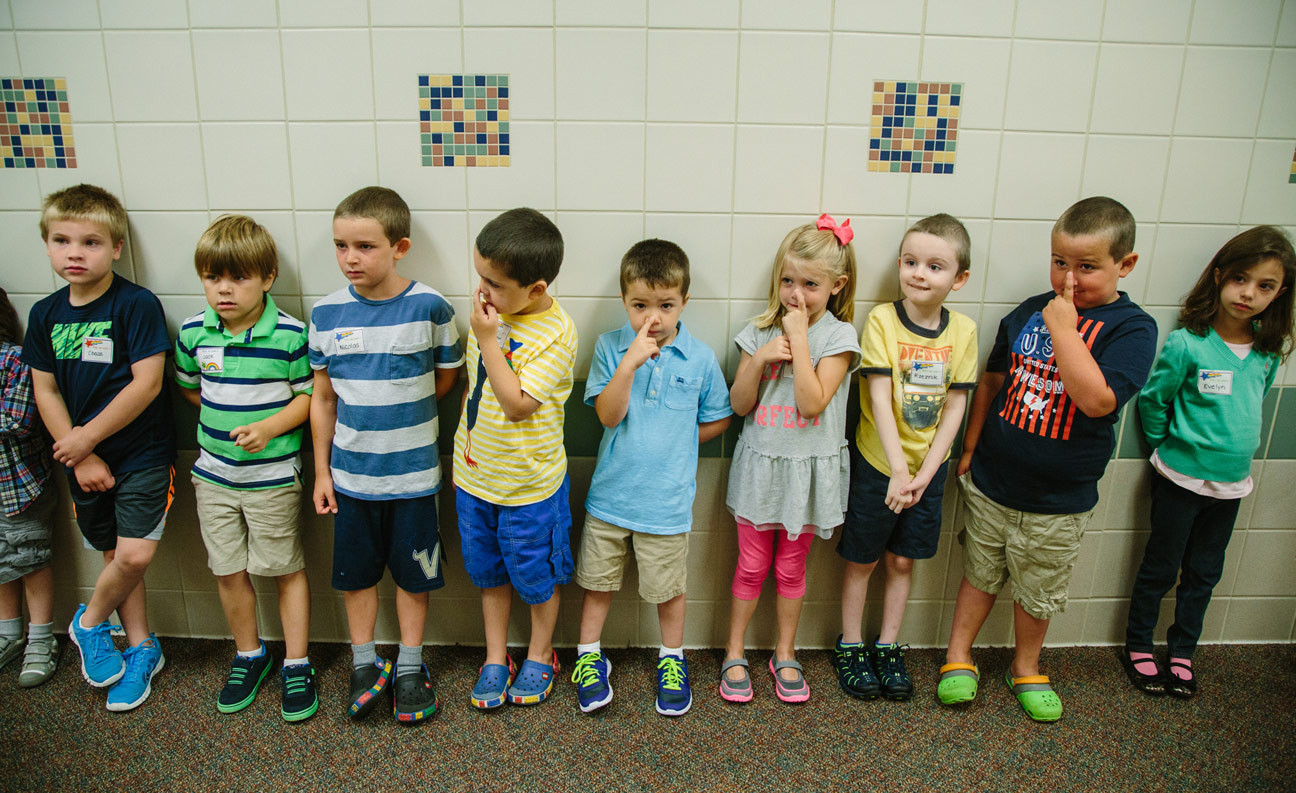 Annette Matthews kindergarten class waits in the hallway during a tour of Osborne Elementary School in Sewickley on the first day of school on August 24, 2015. (Andrew Rush/Post-Gazette)