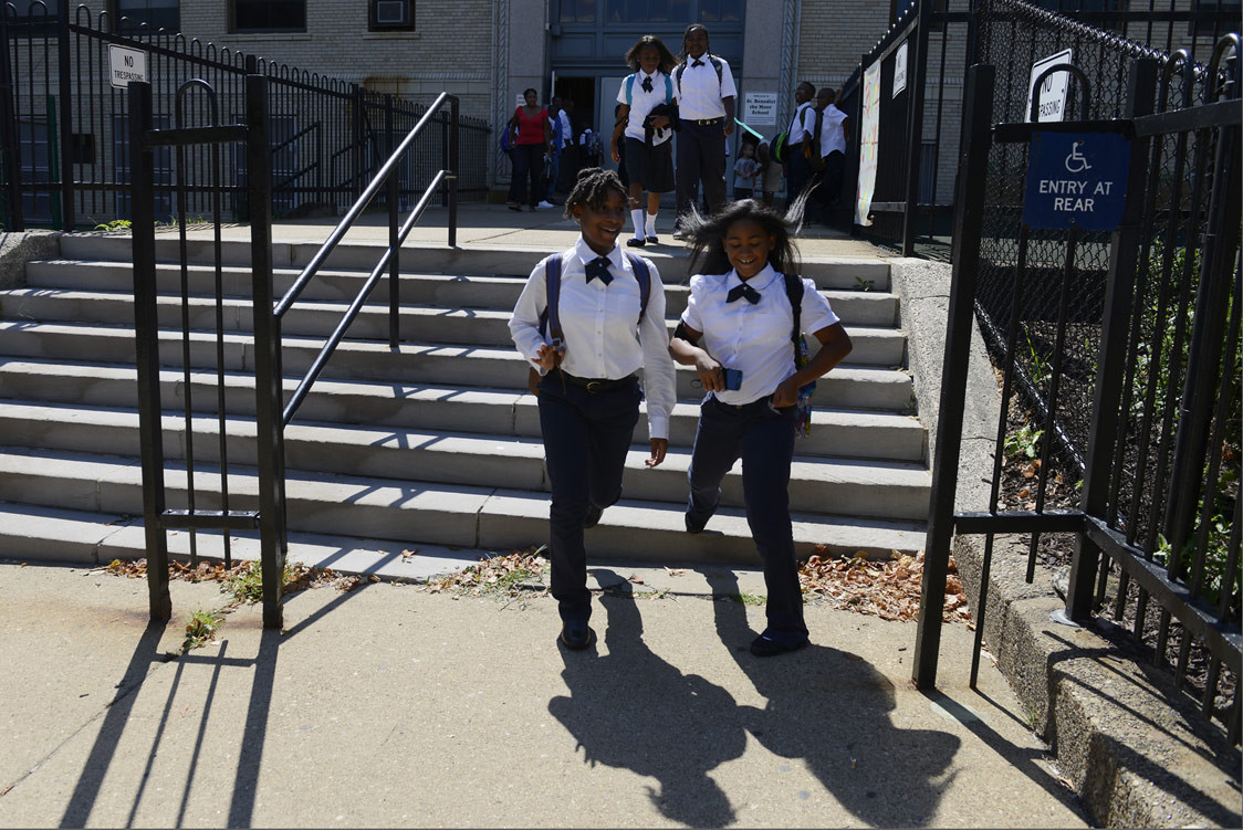 Constance Thompkins, 9, and Danyel White, 10, head out of school at St. Benedict the Moor School in the Hill District on Aug. 24, 2015. (Rebecca Droke/Post-Gazette)